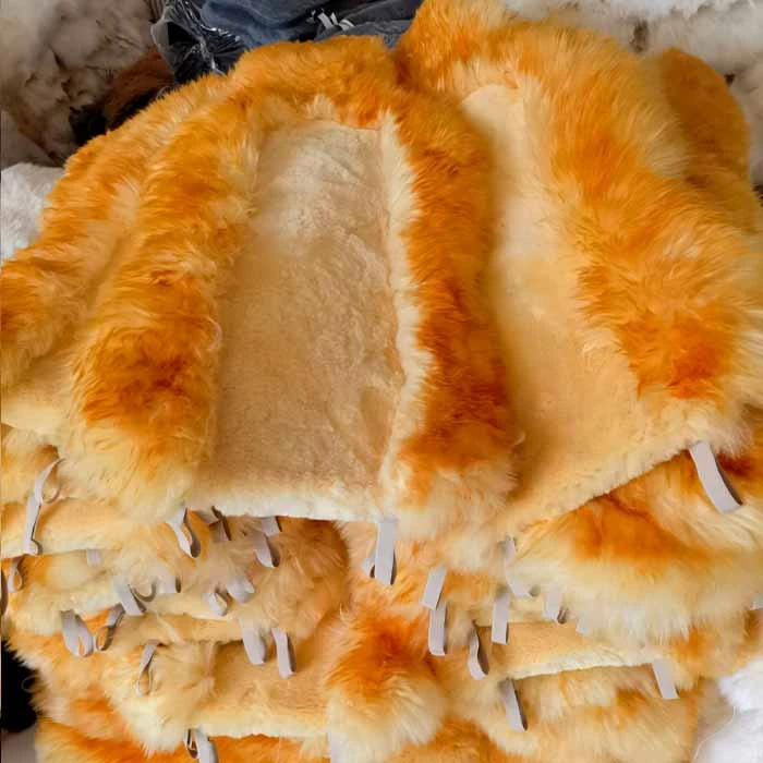 beige color with golden tip Sheepskin car seat covers stacked together