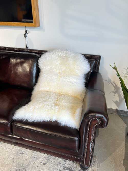 A sheepskin rug was laid on the leather sofa