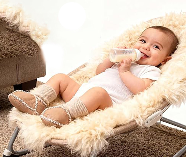 baby lies on the sheepskin rug