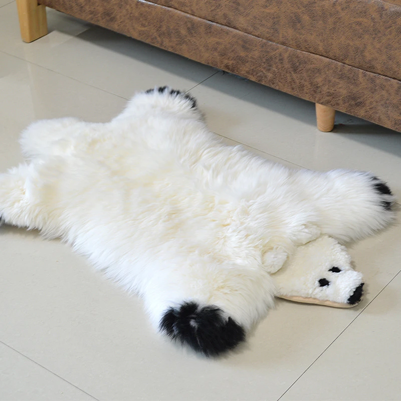 A cute polar bear rug was laid on the floor.